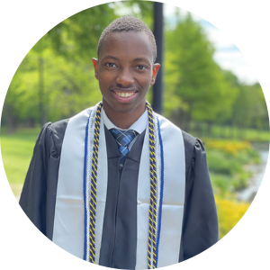 Photo of Henri in graduation robes