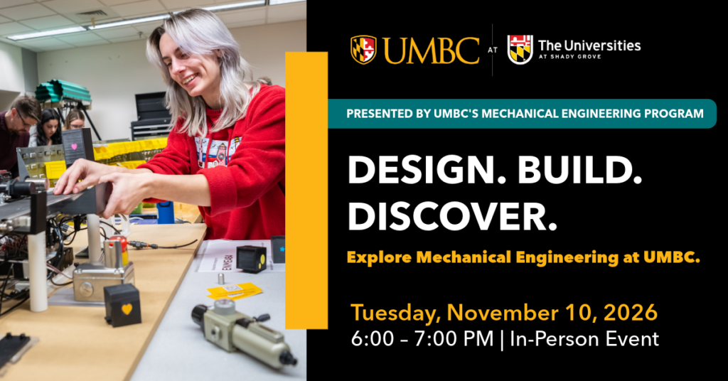 Woman with bleached hair and wearing a red sweatshirt is in a mechanical engineering lab